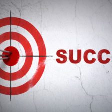 Finance concept: target and Success on wall background