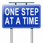 Illustration depicting a roadsign with a one step at a time concept. White background.