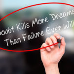 Man Hand writing Doubt Kills More Dreams Than Failure Ever Will with black marker on visual screen. Life, destiny concept.