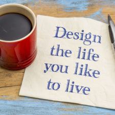 Design the life you like to live - handwriting on a napkin with a cup of coffee